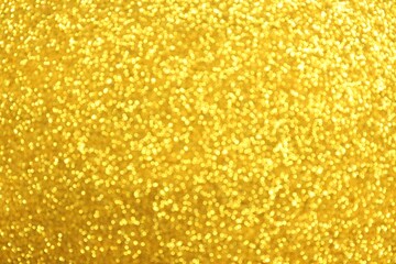 Beautiful golden shiny glitter as background, top view