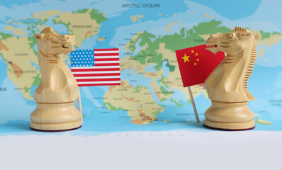 Chess pieces, American and Chinese flags on world map. Trade war concept