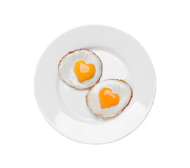 Plate with tasty fried eggs with yolks in shape of heart on white background, top view