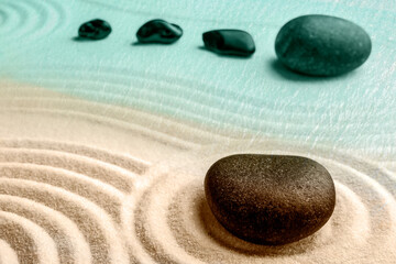 Fototapeta na wymiar Black stones on sand with pattern. Zen, meditation, harmony