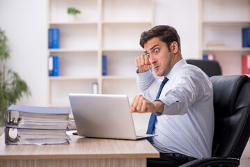 Young male employee working in the office