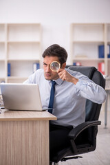 Young male employee working in the office