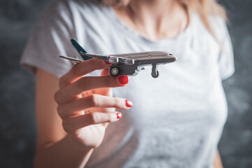 girl holding a toy plane in her hand