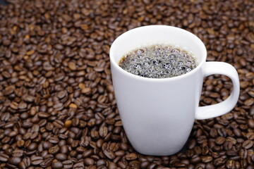 Cup of coffee with perfect roasted coffee beans