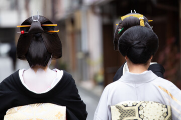 Traditional geisha out and about walking in Gion Kyoto Japan .
