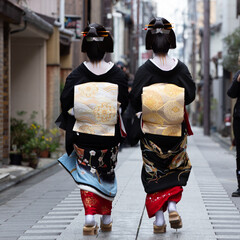 Traditional geisha out and about walking in Gion Kyoto Japan .
