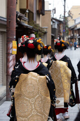 Traditional geisha out and about walking in Gion Kyoto Japan .
