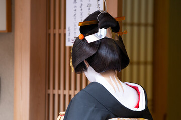 Traditional geisha out and about walking in Gion Kyoto Japan .
