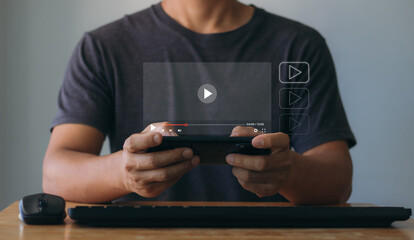 Online movie streaming with a smartphone. Young man watching a movie on a mobile phone with an imaginary video player service. Game streaming online, watching videos, live concerts, shows, tutorials.