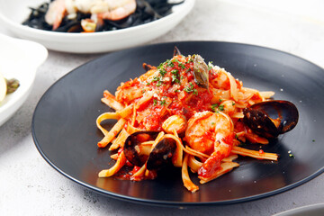 Freshly cooked seafood pasta in marinara sauce