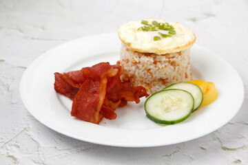 Freshly cooked Filipino food called Bacon Silog or fried bacon, egg and fried rice