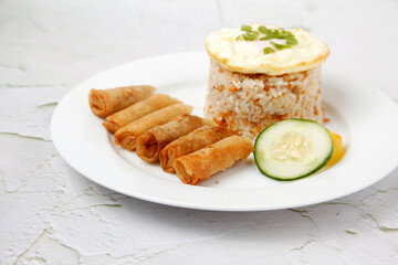Freshly cooked Filipino food called Shanghai Silog or fried spring roll, egg and fried rice