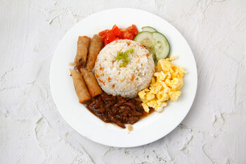Freshly cooked Filipino food called Budbod rice with fried egg, fried spring roll and beef tenders