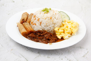 Freshly cooked Filipino food called Budbod rice with fried egg, fried spring roll and beef tenders