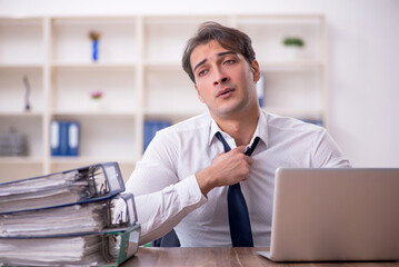 Young male employee working in the office