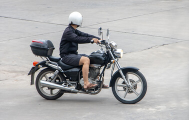 Fototapeta na wymiar A man rides a classic touring motorcycle