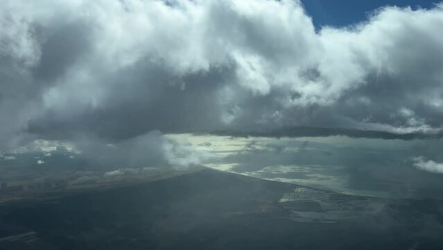 Pilot point of view from a jet cockpit flying over the Gufl of Cadiz, Spain, during descent through some stratus clouds. 4k