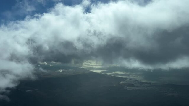 Pilot point of view while flying near Gulf of Cadiz, Spain, during descent, with a blue sunny sky flying southward.4k