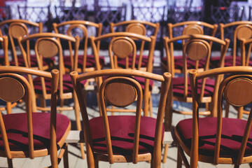 View of big concert hall theater before the show, empty venue for philharmoniс opera with audience, line of wooden chairs, symphony orchestra preparing to perform classical music in the background