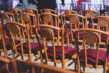 View of big concert hall theater before the show, empty venue for philharmoniс opera with audience, line of wooden chairs, symphony orchestra preparing to perform classical music in the background