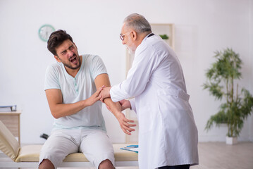 Young male patient visiting old male doctor