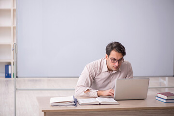 Young male student in telelearning concept