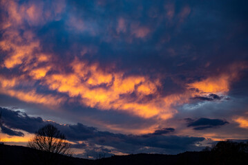 Beautiful Sunset in the Mountain with Orange and Blue Clouds.
