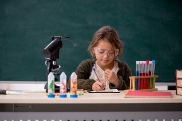 Young little girl chemist in drugs synthesis concept