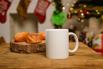 Obraz na płótnie Canvas White cup on wooden table. Mug and breads on table with christmas background.