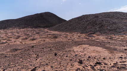 Dark desert with two volcanic hills, Lobos Island, Canary Islands, Spain