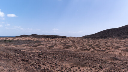 Dark flat volcanic desert area around Lobos Island, Spain