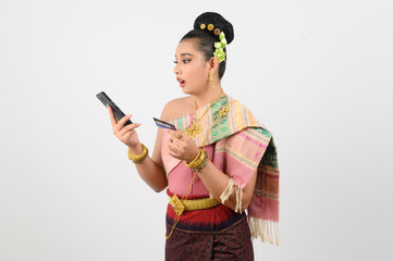 Young beautiful woman in northeastern dress use smartphone and credit card posture