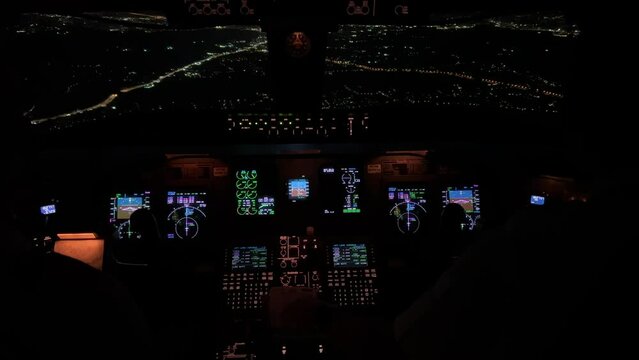 Unique view from a jet cockpit during a real  instrument approcah to Athens airport at night overflying the city.