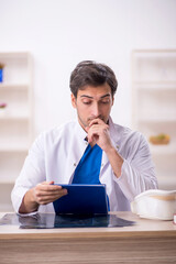 Young male doctor working in the clinic