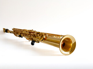 Soprano Sax, wind instrument saxophone lying on a white background, copy space
