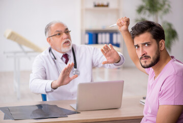 Young male patient visiting old male doctor