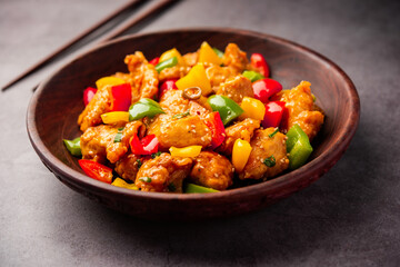 Chilli chicken which is a popular Indo-Chinese starter dish, served on a plate or bowl. Selective focus