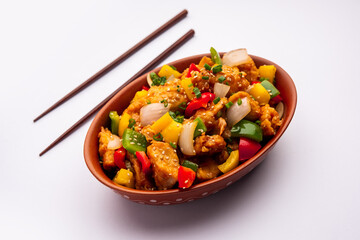 Chilli chicken which is a popular Indo-Chinese starter dish, served on a plate or bowl. Selective focus