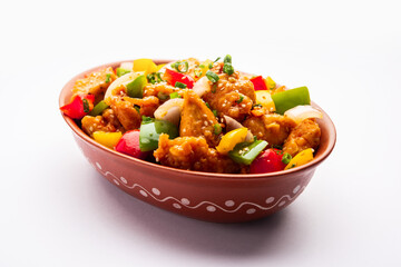 Chilli chicken which is a popular Indo-Chinese starter dish, served on a plate or bowl. Selective focus