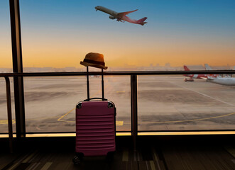 Pink  travel suitcases in the airport terminal waiting area, summer vacation concept, traveling and...