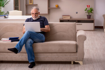 Fototapeta premium Old male employee working from home during pandemic