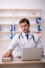 Young male doctor working in the clinic