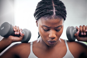 Black woman, weightlifting dumbbells and gym with focus, strong body or muscle for health, wellness...