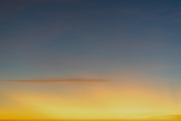 The dramatic colors of the sunset in the sky gradient from blue to orange.