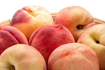 Fresh Sweet Peach on pink wooden  basket, Pink and yellow Peach fruit with leaf on bamboo basket isolate on white.
