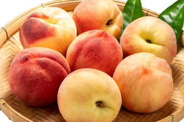Fresh Sweet Peach on pink wooden  basket, Pink and yellow Peach fruit with leaf on bamboo basket isolate on white.