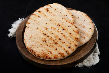 .Pita bread on dark background. Arabic, lebanese bread, traditional food.