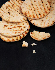 .Pita bread on dark background. Arabic, lebanese bread, traditional food.
