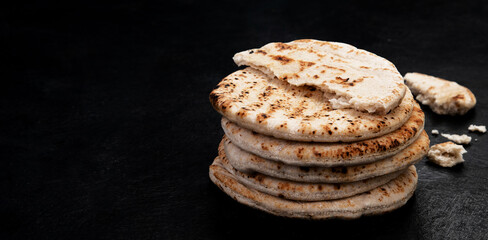 .Pita bread on dark background. Arabic, lebanese bread, traditional food.