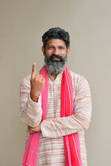 Young Indian farmer showing finger after voting. voting sign in india